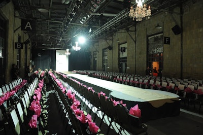 Gift bags with items from the participating brands topped chairs in the runway room.