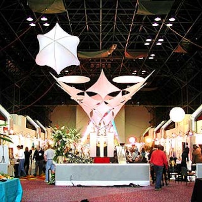 Pink Inc.'s 'tree of life' decor installation soared to the ceiling of the trade show floor in a web of white tensile fabric.