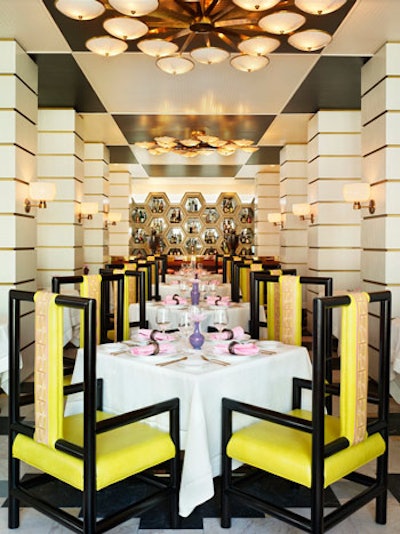 The main dining room features geometric shapes, bold colors, and elaborate chandeliers