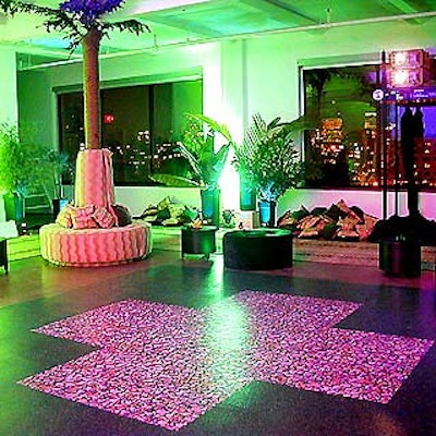 The adventure-themed room was filled with green lights and plants, black and tan seating, and a dance floor printed with pictures of grass and rocks. (Photo courtesy of Tentation)