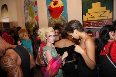 The fashion show took place on the ground floor of the Artomatic Building in the Electric Stage area, where models and guests could peruse the local artwork on view.