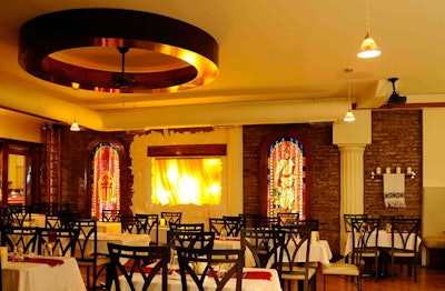 Stained glass panels and an onyx waterfall accent the main dining room, which seats 69 guests.