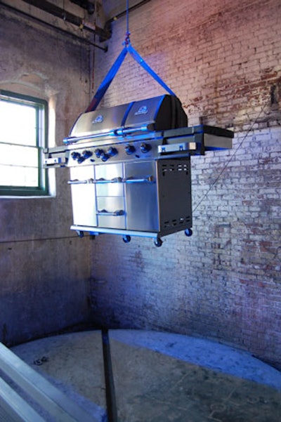 A barbecue—and live auction item—from event sponsor Broil King hung from the ceiling just inside the Fermenting Cellar.