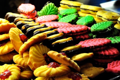 An assortment of cookies, including the cherry-topped Hollander, Teddy bears, strawberry and pistachio leaf cookies, and pretzels.