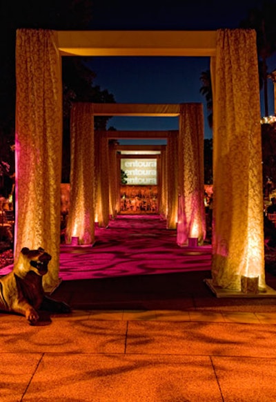 Five high arches with embroidered curtains suggested a proscenium stage in a hall of mirrors.