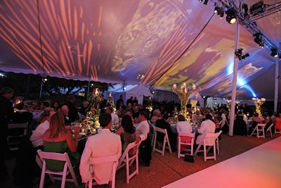 Frost illuminated the top of the dinner tent with images of zoo animals and prairie grass.