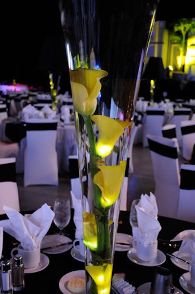 AB Cover Designers created lamp-style centerpieces with yellow calla lilies floating in tall clear vases topped with large black lamp shades.