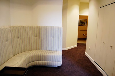 A wraparound banquette forms a seating area outside the manicure and pedicure room.