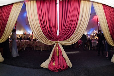 Tasseled gold and maroon drapes framed the entrance to the dinner tent.