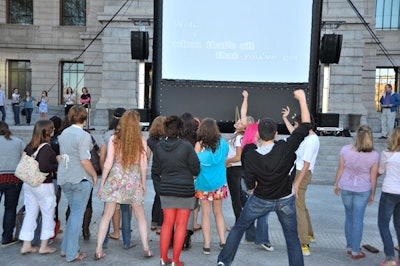 Attendees sang, danced, and vogued along to the giant projector screen.