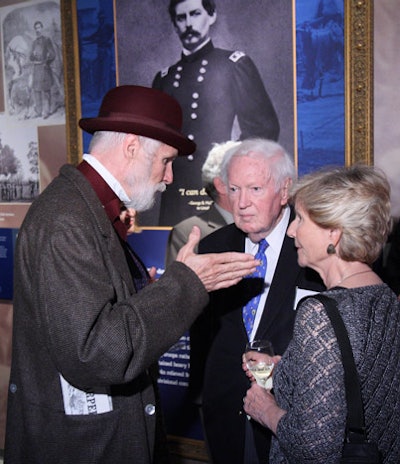 Volunteer interpreters wearing Civil War period costumes mingled with guests touring the theater and museum.