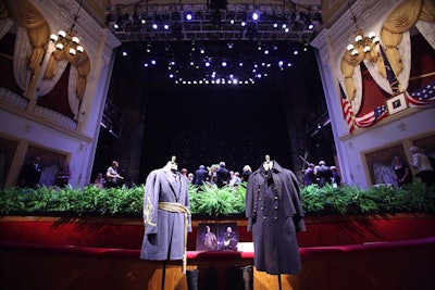 To prevent anything—or anyone—from sliding off the stage, a ring of ferns lined the edge, where costumes from The Civil War were on display.