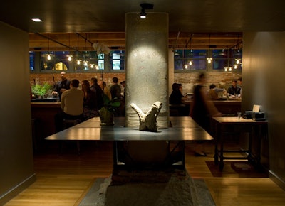 The subterranean bar preserves elements of the venue's industrial past, like a brick wall and exposed piping.