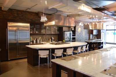 A stone wall provides a backdrop to the chef's station.