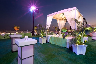 White canopies covered buffets, and white lighting illuminated tall cocktail tables from within.