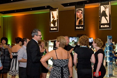 Attendees mingled beneath the hairstyling association's signage.
