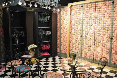 Betsey Johnson's booth included the signature fabric-covered walls, blue chandelier, and black furniture seen in many of her boutiques.