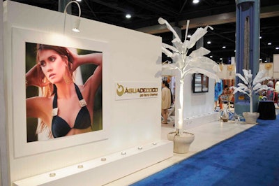 Brazilian label Agua de Coco contracted ASI Displays to create its white beach-themed booth complete with white palm trees at the entrance.
