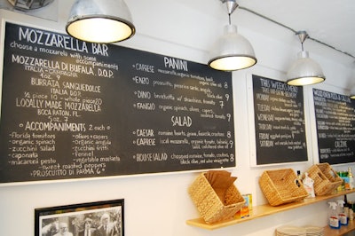 The chalkboards above the pizza bar list standard menu items as well as weekly specials.