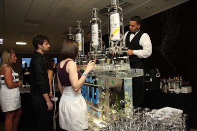 Guests lined up for blue specialty cocktails at Ketel One's ice martini bar.