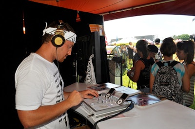 A DJ mixed iPod tunes inside the Kia tent.