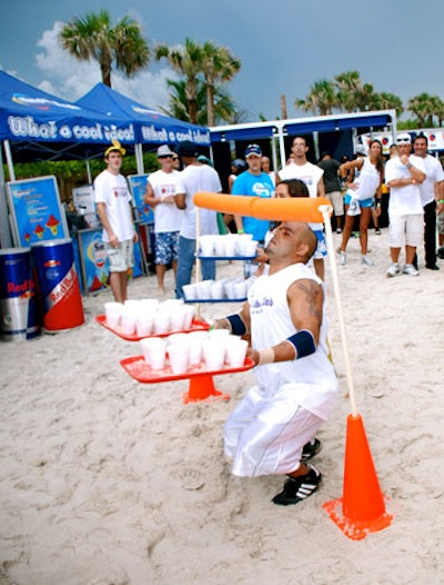 The second participant in the race had to add water to the sand-filled cups, place them on a tray, and limbo under a pole before passing off the cups to the third person on the relay team.