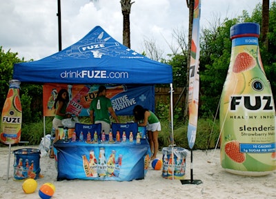 Fuze Beverage set up a branded tent with a giant inflatable bottle of its Strawberry Melon drink next to it.