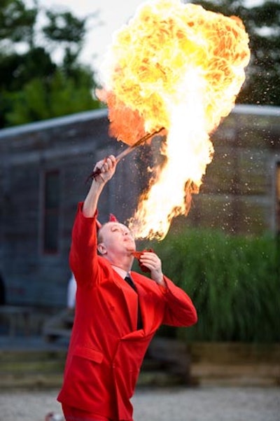 If God is in the details, what is the devil in? This performer blew gas flame clouds, extinguished burning torches in and out of his mouth—you know, the usual.