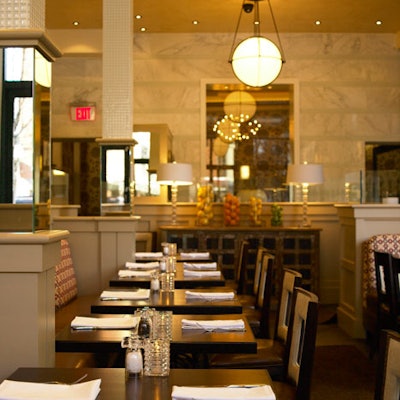 Herringbone floors, chandeliers, and mirrors line the main dining room.