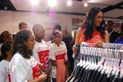 Swarmed by photographers, Kimora Lee Simmons led a shopping tour, escorting kids from the Children's Aid Society around the new store.