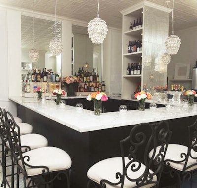 Decked with pressed tin ceilings and crystal chandeliers, the private dining room at Jane's also has a marble bar.