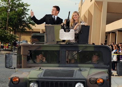 Channing Tatum and Sienna Miller arrived in a Humvee, waving to guests from the gun turret.
