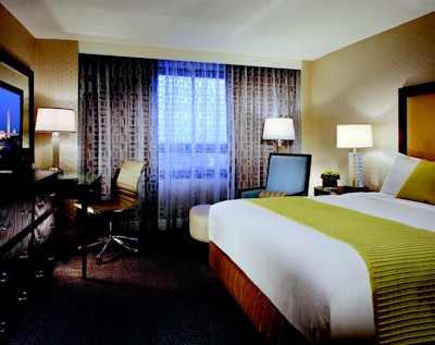 Renovated and enlarged guest rooms have textured ivory wall coverings, dark wood finishes, and work stations with an ergonomic desk chair.