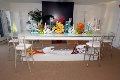 Installations made from faux coral and orchids decorated tabletops.
