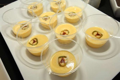 A buffet offered yellow tomato gazpacho topped with a jalapeno garnish.