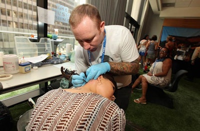 Tattoo artists offered complimentary services for guests at the Music Lounge.