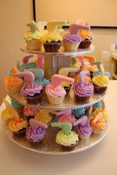 Cupcakes adorned with mini hairdryers filled a cake stand on the front counter.