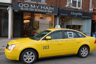 A taxi cab covered with Do My Hair decals was parked outside the Mount Pleasant salon.