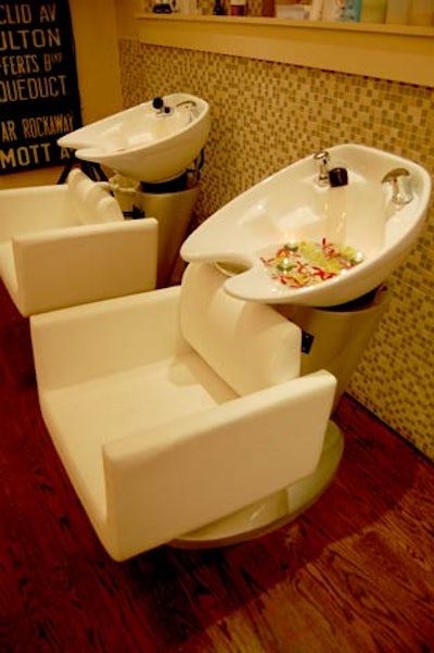 Candles and flowers from Quince Flowers floated in the sinks at the salon's two shampoo stations.