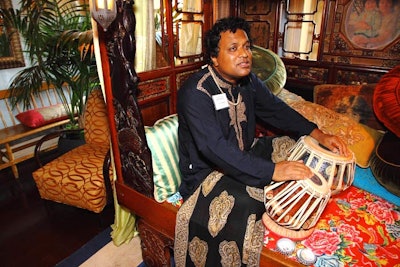 Native to west India, Naren Budhkar played the tabla, an Indian percussion instrument, in one of the venue's ornately decorated rooms.