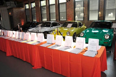 Silent auction tables formed a line in front of the venue's collection of vintage cars.