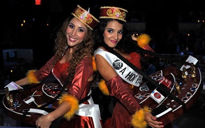 Two old-fashioned cigarette girls from A Hot Party circulated with trays of real and chocolate cigars for attendees.