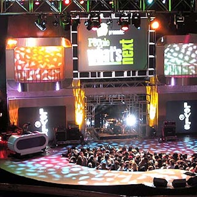 Before the performance, the set featured shifting sponsor names on the two smaller screens on both sides of the stage.