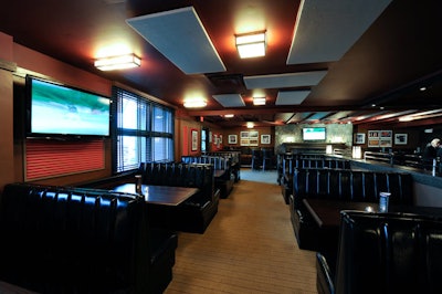 Spacious black leather booths and flat-screen TVs accent the main dining room.