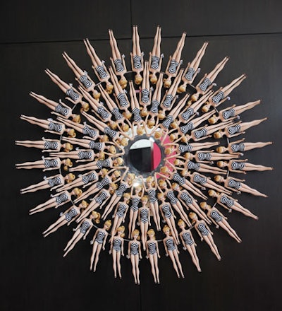 Barbie dolls deck a round mirror.