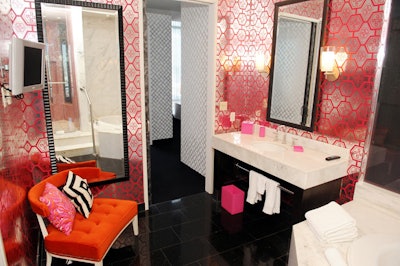 Pink and orange tones and graphic patterns decorate a bathroom in the suite.