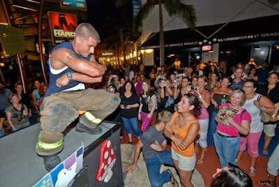 One of the men asked a woman in the crowd to help him take his shirt off.