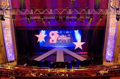 The fashion show took place at the Chicago Theatre, where a backdrop showcased the Glamorama logo and Macy's signature stars framed the stage.