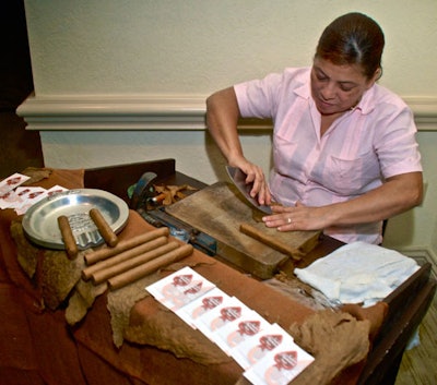 A representative from Sabor Havana Cigar rolled cigars during the reception.