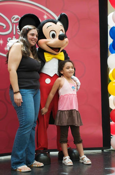 Mickey and Minnie posed for pictures with guests in center court following the ribbon-cutting ceremony at the store.